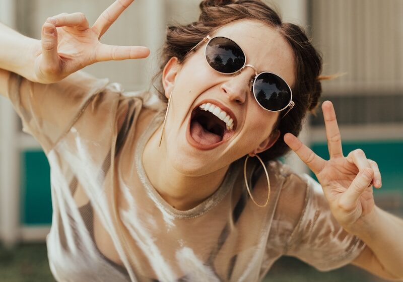 Photo by Brooke Cagle selective focus photography of jolly woman using peace hand gesture