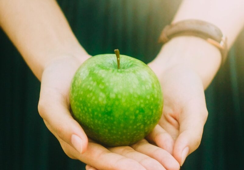 Photo by Jony Ariadi person holding green apple