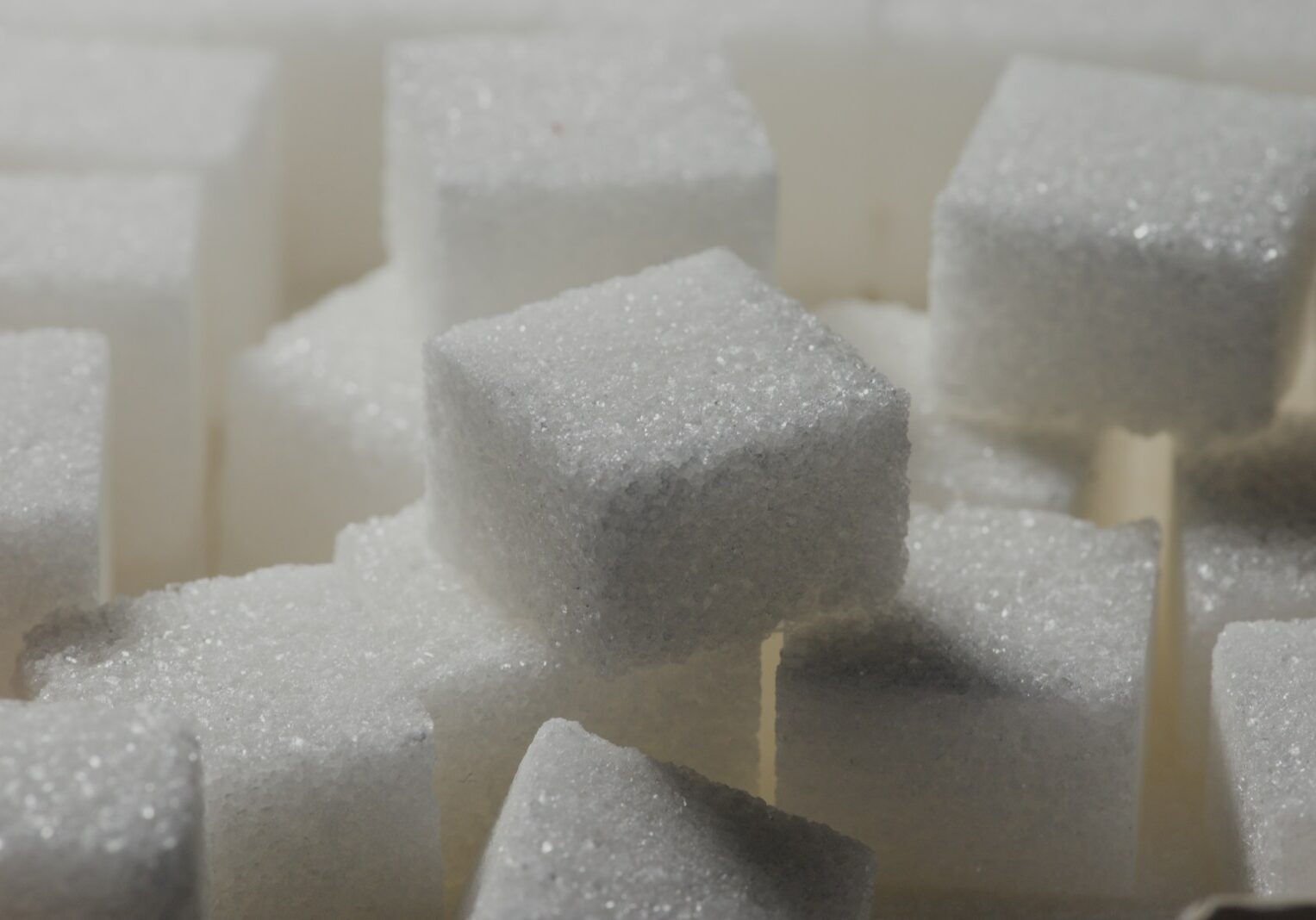 Photo by Daniel Kraus a pile of sugar cubes sitting on top of each other